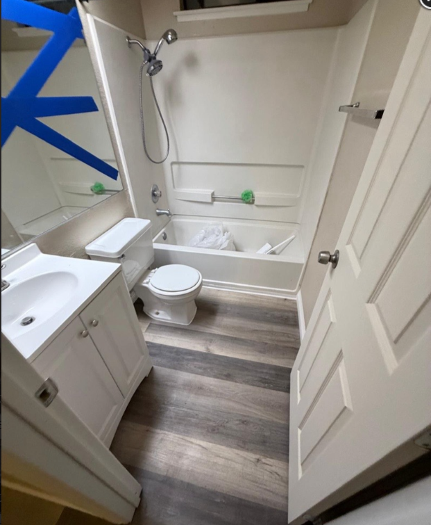 Completed bathroom renovation with new flooring and finishes