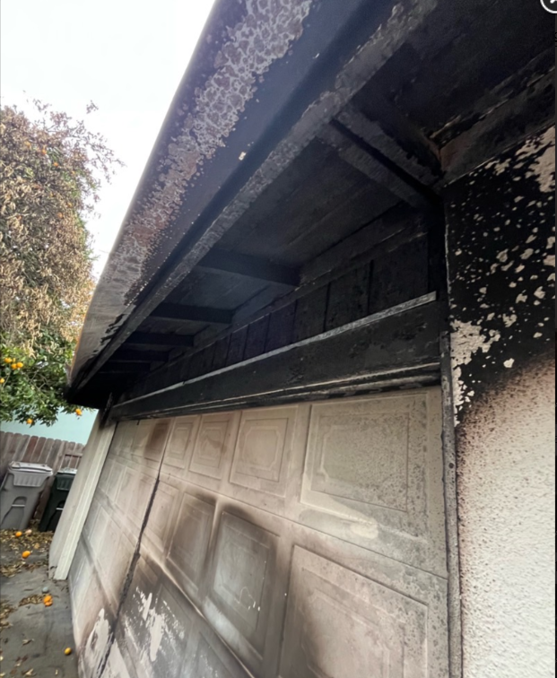 Garage exterior with fire and smoke damage