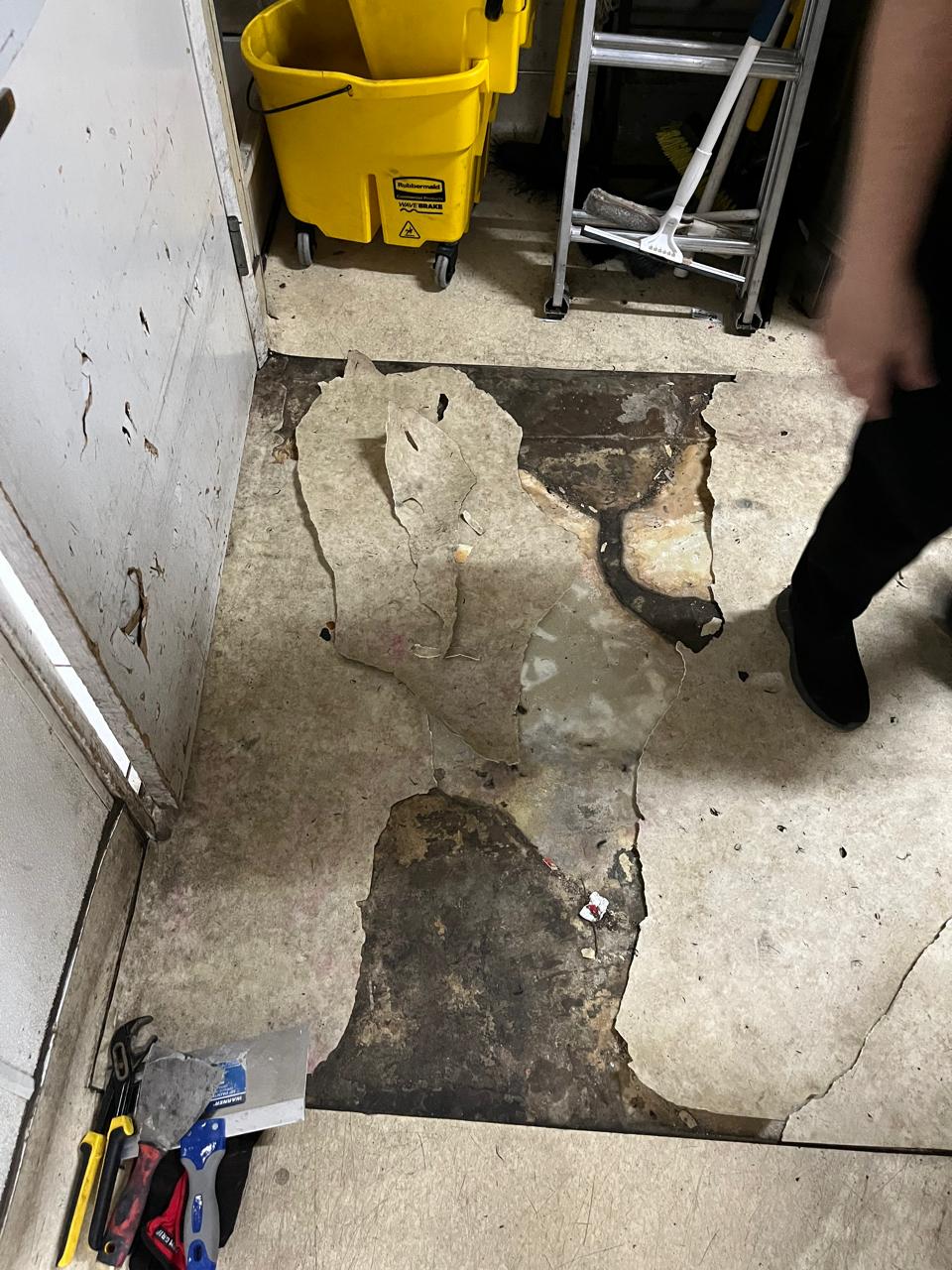 Damaged commercial floor before repair